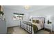 Stylish bedroom featuring new vinyl floors, a cozy bed, and a bright window at 7904 Fossil Creek Ln # 101, Las Vegas, NV 89145