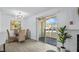 Dining area with a sliding glass door, modern lighting, and wicker chairs at 7904 Fossil Creek Ln # 101, Las Vegas, NV 89145
