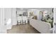 Inviting open-concept living area with modern decor, flowing seamlessly into the kitchen and dining space at 7904 Fossil Creek Ln # 101, Las Vegas, NV 89145