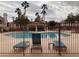 Community pool area with comfortable lounge chairs and shaded cabana, perfect for relaxation at 7904 Fossil Creek Ln # 101, Las Vegas, NV 89145