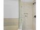 Luxurious shower showcasing elegant marble tiling, a frameless glass door, and a convenient shower niche at 7904 Fossil Creek Ln # 101, Las Vegas, NV 89145