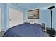 Cozy bedroom featuring painting over bed, white closet doors, and floor lamp at 8468 W Gilmore Ave, Las Vegas, NV 89129