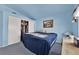 Blue bedroom with double closet and a window providing natural light at 8468 W Gilmore Ave, Las Vegas, NV 89129