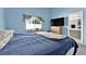 Bedroom with blue walls, carpet, and window view of the backyard at 8468 W Gilmore Ave, Las Vegas, NV 89129