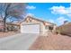 Charming single-story home with a two-car garage and low maintenance desert landscaping at 8468 W Gilmore Ave, Las Vegas, NV 89129