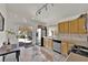 Well-lit kitchen with stainless steel appliances, tile flooring, and convenient access to the patio at 8468 W Gilmore Ave, Las Vegas, NV 89129
