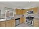 Well-lit kitchen featuring stainless appliances and natural wood cabinets at 8468 W Gilmore Ave, Las Vegas, NV 89129
