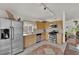 Bright kitchen features stainless appliances, natural wood cabinets, and stylish tile flooring at 8468 W Gilmore Ave, Las Vegas, NV 89129