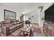 Bright living room featuring a leather sofa, modern decor, and lots of natural light at 8468 W Gilmore Ave, Las Vegas, NV 89129