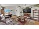 Bright living room featuring modern decor, a leather sofa, and lots of natural light at 8468 W Gilmore Ave, Las Vegas, NV 89129