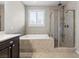 Bright bathroom with a soaking tub and a glass-enclosed shower at 8863 Nolene Stream St, Las Vegas, NV 89131