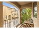 Relaxing balcony view with table and chair, overlooking neighborhood homes and trees at 8932 Jaquita Ave, Las Vegas, NV 89149
