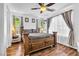 Primary bedroom featuring hardwood floors, ceiling fan, side tables and a gorgeous wood bed frame at 8932 Jaquita Ave, Las Vegas, NV 89149