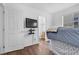 Bedroom featuring hardwood floors, ceiling fan and a television mounted on the wall at 8932 Jaquita Ave, Las Vegas, NV 89149