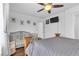 Well-lit bedroom featuring a ceiling fan, hardwood floors and a connecting door to an attached bathroom at 8932 Jaquita Ave, Las Vegas, NV 89149