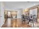 Open dining area features hardwood flooring and a view of the stairs to the second story at 8932 Jaquita Ave, Las Vegas, NV 89149