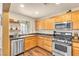 Well-lit kitchen features stainless steel appliances, light wood cabinets, and modern fixtures at 8932 Jaquita Ave, Las Vegas, NV 89149
