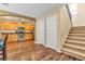 Open living room with hardwood floors and a view into the kitchen and stairway to the second floor at 8932 Jaquita Ave, Las Vegas, NV 89149