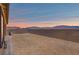 Sunset view of the fenced backyard with desert landscaping at 10186 Zeta Tucana St, Las Vegas, NV 89143