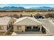 A large, fenced backyard with a covered patio. Mountains are in the background at 10186 Zeta Tucana St, Las Vegas, NV 89143