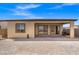 View of the back of the home from the yard, including the covered patio at 10186 Zeta Tucana St, Las Vegas, NV 89143