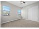 Comfortable bedroom featuring soft carpet, two windows, and a closet for ample storage space at 10186 Zeta Tucana St, Las Vegas, NV 89143