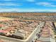 Expansive aerial view of a new residential community with many homes and neighborhood streets, set against a mountain backdrop at 10186 Zeta Tucana St, Las Vegas, NV 89143