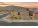 Charming single-story home with well-manicured landscaping and mountain views at sunset at 10186 Zeta Tucana St, Las Vegas, NV 89143