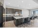 Modern kitchen featuring a large center island, quartz countertops, and stylish seating at 10186 Zeta Tucana St, Las Vegas, NV 89143