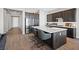 Modern kitchen boasting a spacious island, stainless steel appliances, and stylish dark cabinetry at 10186 Zeta Tucana St, Las Vegas, NV 89143