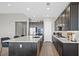 Contemporary kitchen with dark cabinetry, stainless steel appliances, and sleek countertops at 10186 Zeta Tucana St, Las Vegas, NV 89143