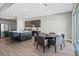 Open-concept kitchen and dining area with gray accents and wood-look tile flooring at 10186 Zeta Tucana St, Las Vegas, NV 89143