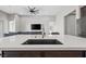 Modern kitchen featuring a stainless steel sink with quartz countertops and an open floor plan at 10186 Zeta Tucana St, Las Vegas, NV 89143