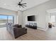 Spacious living room with tile floors, a ceiling fan, and a sliding glass door at 10186 Zeta Tucana St, Las Vegas, NV 89143