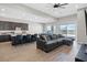Spacious living room with an adjacent kitchen, creating an open and inviting area for relaxation at 10186 Zeta Tucana St, Las Vegas, NV 89143