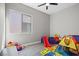 playroom with a colorful mat, play tent, and large window providing natural light at 10186 Zeta Tucana St, Las Vegas, NV 89143