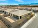 The rear exterior of a single-Gathering home is surrounded by a block wall for privacy and has mountain views at 10186 Zeta Tucana St, Las Vegas, NV 89143