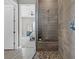 Tiled shower with a mosaic floor, built-in bench, and view into the bedroom at 10186 Zeta Tucana St, Las Vegas, NV 89143