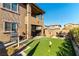 Charming backyard featuring well-maintained artificial grass, patio, and outdoor grill at 12381 Liberty Beacon Ave, Las Vegas, NV 89138
