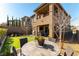 Beautiful backyard featuring a putting green, patio seating, a built-in grill, and manicured landscaping at 12381 Liberty Beacon Ave, Las Vegas, NV 89138