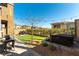 Inviting backyard space with a grill, spa, and artificial grass at 12381 Liberty Beacon Ave, Las Vegas, NV 89138