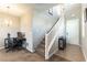 Inviting entryway with staircase leading to the second floor, office nook and tiled flooring at 12381 Liberty Beacon Ave, Las Vegas, NV 89138