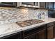 Granite counters and stainless steel gas cooktop stove at 12381 Liberty Beacon Ave, Las Vegas, NV 89138