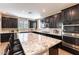 This modern kitchen boasts a large island, stainless steel appliances, and dark cabinets at 12381 Liberty Beacon Ave, Las Vegas, NV 89138