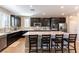 Modern kitchen with stainless steel appliances, granite countertops, a large island, and dark cabinetry at 12381 Liberty Beacon Ave, Las Vegas, NV 89138