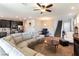 Bright and airy living room showcasing a comfortable sofa, open layout, and seamless flow to the kitchen at 12381 Liberty Beacon Ave, Las Vegas, NV 89138