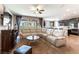 Spacious living room featuring a plush sectional couch and stylish decor, open to the kitchen at 12381 Liberty Beacon Ave, Las Vegas, NV 89138