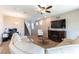 Comfortable living room with a fireplace, TV, staircase, and a relaxed seating arrangement at 12381 Liberty Beacon Ave, Las Vegas, NV 89138