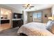 Inviting main bedroom with TV, ceiling fan, balcony access, and en suite bath at 12381 Liberty Beacon Ave, Las Vegas, NV 89138