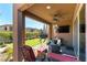 Covered outdoor patio with comfortable seating, a ceiling fan, and a view of the backyard at 12381 Liberty Beacon Ave, Las Vegas, NV 89138